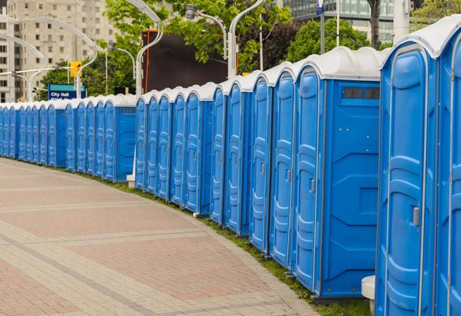 a row of portable restrooms set up for a large athletic event, allowing participants and spectators to easily take care of their needs in Centerport